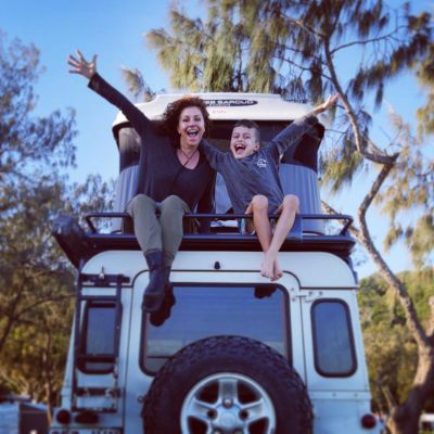 Simmone Jade Mackinnon and her son, Madigan James Mackinnon posing for a photo shoot while sitting on top of Land Rover.